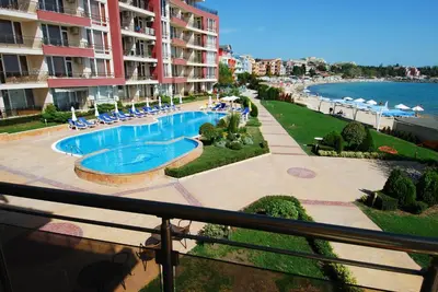 a view of a swimming pool from a balcony of a building at Aurelia Beach Complex in Ravda
