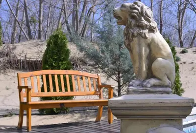 a statue of a lion next to a bench at Dune Residence Apartments in Sunny Beach