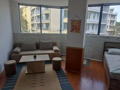 a living room with a couch and a table at Rainbow Luci in Sunny Beach