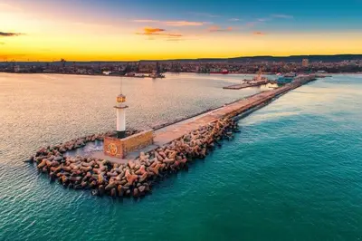 an island in the water with a lighthouse on it at Varna Hidden Gem in Varna City