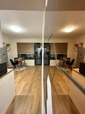 a living room with wooden floors and a glass wall at Varna Hidden Gem in Varna City