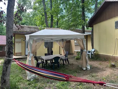 a tent with a table and chairs under it at Бунгала Мишел in Varna City