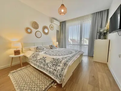 a bedroom with a bed and a large window at Prestige Fort Aparthotel - Private apartment - BSR - 2 in Sveti Vlas