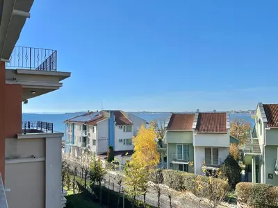 a view of houses and the ocean from a balcony at Prestige Fort Aparthotel - Private apartment - BSR - 2 in Sveti Vlas