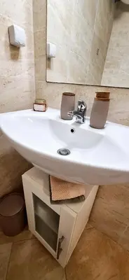 a bathroom with a white sink and a mirror at Studio M in Sveti Vlas