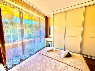a bedroom with a bed and a large window at Sea Sun Holiday Apartments Sunny Beach in Sunny Beach
