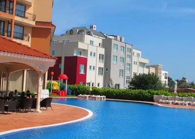 a swimming pool in front of a building at Menada Diamant Apartments in Sunny Beach