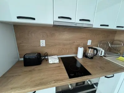 a kitchen with a counter top with a stove top oven at Apartment Bela in Burgas City
