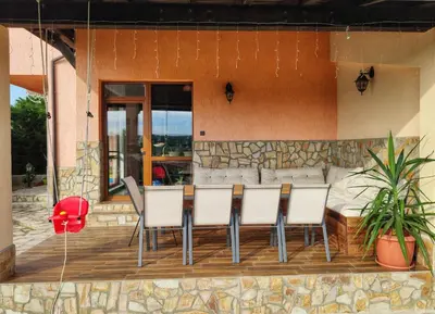 a group of chairs sitting around a table on a patio at Casa Soleada in Bliznatsi