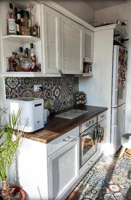a kitchen with white cabinets and a stove top oven at Casa Soleada in Bliznatsi