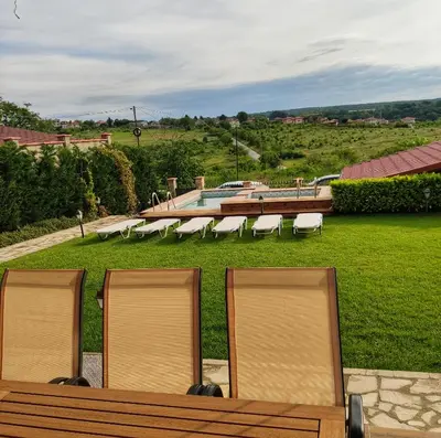 a group of chairs sitting next to a pool at Casa Soleada in Bliznatsi