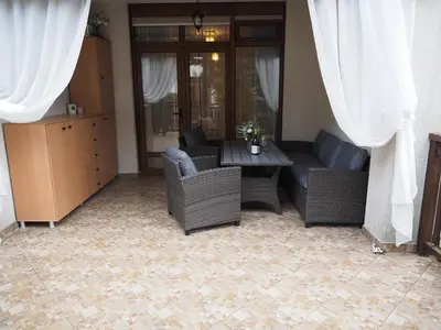 a living room with wicker chairs and a table at Studio Sea Breeze Veranda in Santa Marina in Sozopol