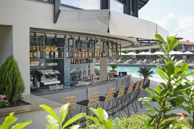 a bar on the side of a building next to a pool at Studio Sea Breeze Veranda in Santa Marina in Sozopol