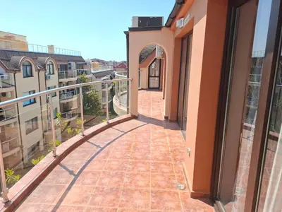a balcony with a view of a building at MAGNOLIA Apartments in Ravda