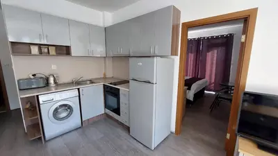 a kitchen with a refrigerator and a washing machine at Sunny Day 6 , Sunny beach, 3-Стаен апартамент in Tŭnkovo