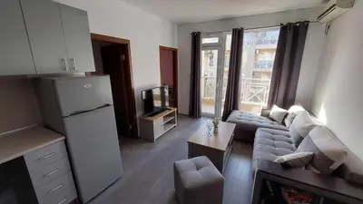 a living room with a couch and a tv at Sunny Day 6 , Sunny beach, 3-Стаен апартамент in Tŭnkovo