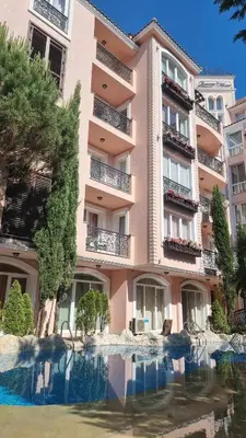 a building with a pool of water in front of it at A wonderful vacation home in Sunny Beach
