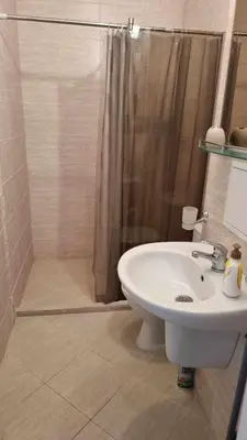 a bathroom with a shower and a white sink at A wonderful vacation home in Sunny Beach