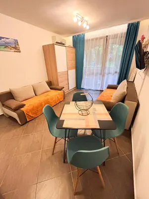 a living room with a couch and a table and chairs at Cascadas Family Studio Komfort dla Dwojga lub Rodziny in Sunny Beach