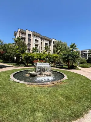a fountain in a park in front of a building at Cascadas Family Studio Komfort dla Dwojga lub Rodziny in Sunny Beach