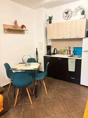 a kitchen with a table and chairs and a sink at Cascadas Family Studio Komfort dla Dwojga lub Rodziny in Sunny Beach
