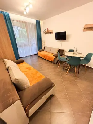 a living room with a couch and a table at Cascadas Family Studio Komfort dla Dwojga lub Rodziny in Sunny Beach