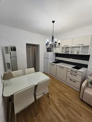 a kitchen and dining room with a white table and chairs at Romans Marin in Sunny Beach