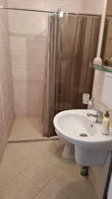 a bathroom with a shower and a white sink at Romans Marin in Sunny Beach