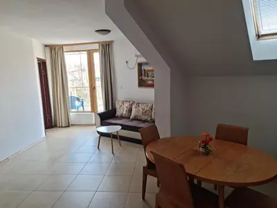 a living room with a table and a couch at Apartment Lermontov in Burgas City