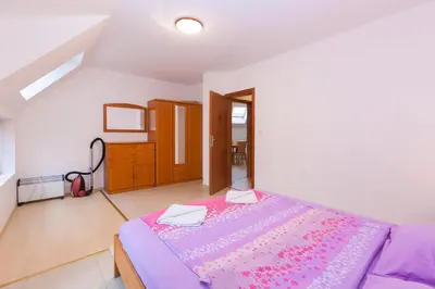 a bedroom with a bed with a purple blanket at Apartment Lermontov in Burgas City