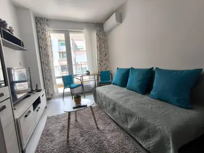 a living room with a couch and a table at Apartment Oborishte in Burgas City