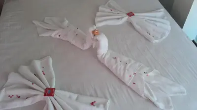 a group of white towels on a bed at Mirage Family Hotel in Primorsko
