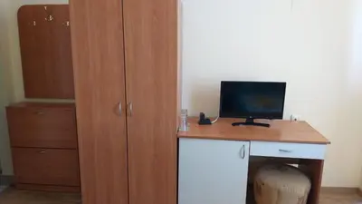 a room with a desk with a computer on it at Ivanovi Guest House in Primorsko