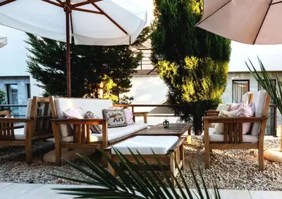 a patio with two chairs and a table and an umbrella at Seaside 1 BR Apartment with balcony, max 4 Guests in Sunny Beach
