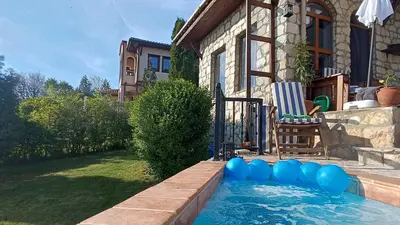 a swimming pool in the backyard of a house at къщи за гости villa Momino in Avren