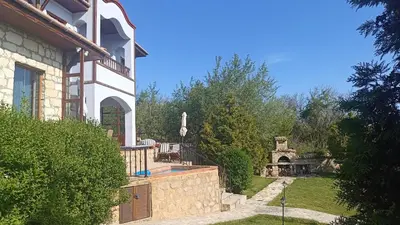a house with a swimming pool and a yard at къщи за гости villa Momino in Avren