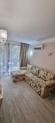 a living room with a couch in a room at 1 bedroom Harmony Monte Carlo in Sunny Beach