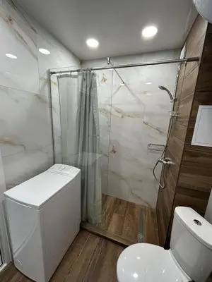 a bathroom with a toilet and a shower at Magic Home in Obzor