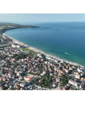 an aerial view of a beach with houses and the water at Magic Home in Obzor
