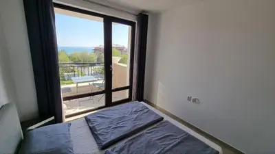 a room with a bed and a large window at Apartment mit Meeresblick Polarstar Beach 2 Zimmer Premium Apartment in Sveti Vlas