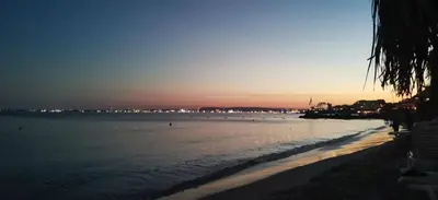 a view of a beach at sunset with the ocean at Apartment mit Meeresblick Polarstar Beach 2 Zimmer Premium Apartment in Sveti Vlas