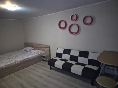 a room with a bed and a couch and plates on the wall at Luxury Apartments Central KIRIL I METODII 3 in Burgas City