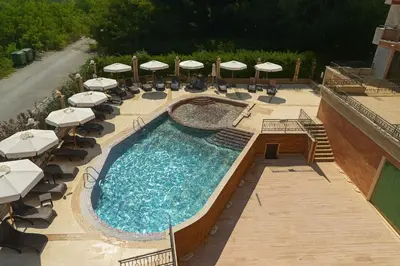 an overhead view of a pool with umbrellas and chairs at River Park Menada Apartments in Sunny Beach