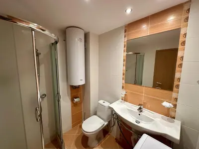 a bathroom with a toilet and a sink and a shower at River Park Menada Apartments in Sunny Beach