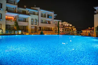 a large blue swimming pool in front of some buildings at Paradise Dreams Menada Apartments in Sveti Vlas