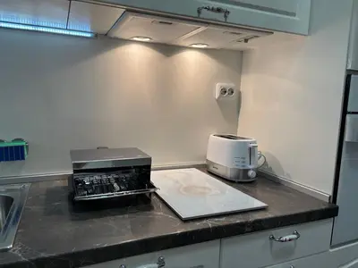 a kitchen counter with a toaster and a coffee maker at Apartment 4 Plus Burgas in Burgas City