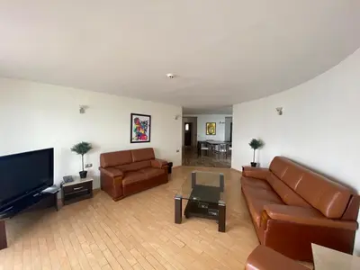 a living room with leather furniture and a flat screen tv at Sozopol Sunrise in Sozopol