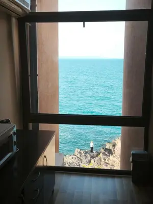 a view of the ocean from a kitchen window at Sozopol Sunrise in Sozopol