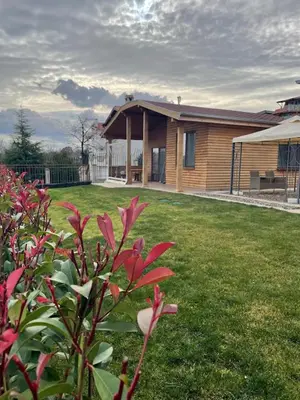 a house with a grass yard with a house at Вили Панорама 2 in Chernomorets