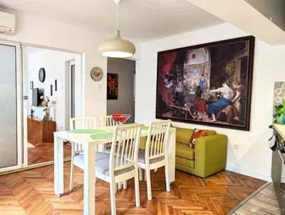 a dining room with a table and a couch at Seaside luxury residence in Varna City